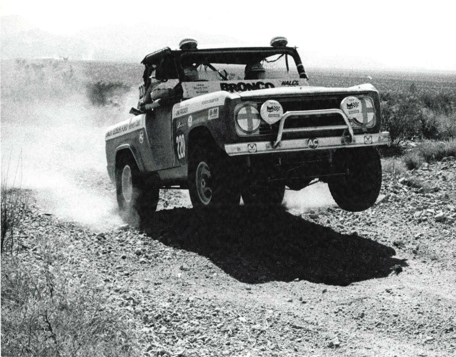 Off-road racing vehicles navigating rugged desert terrain with two way radios in action
