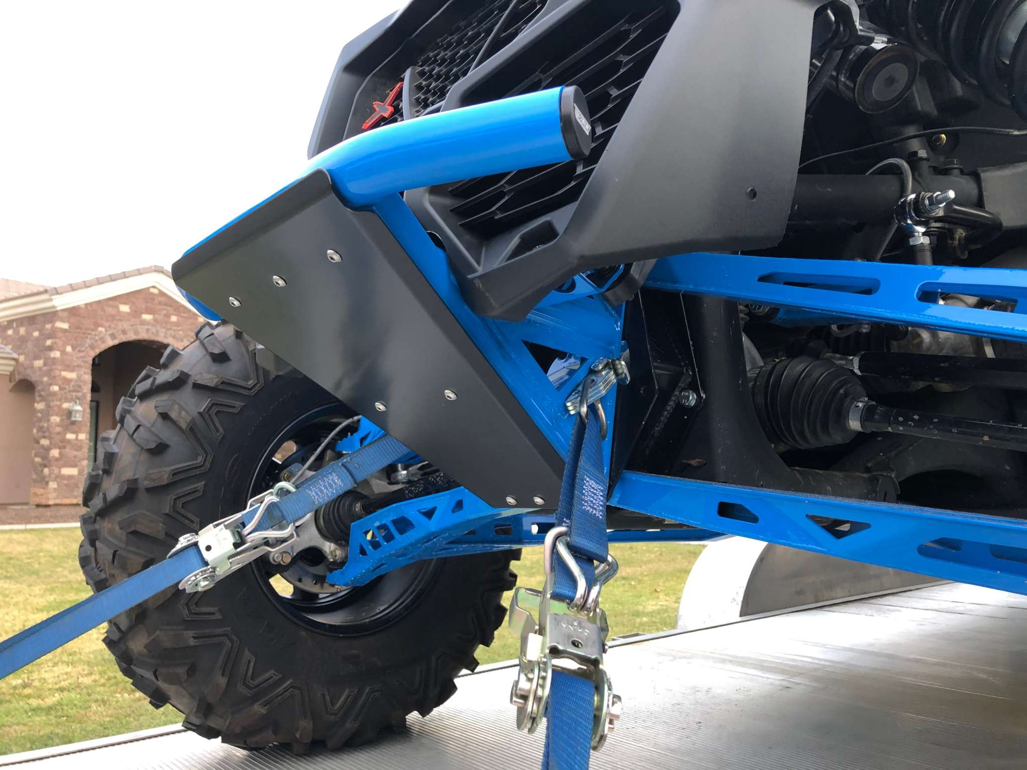TMW Prerunner bumper skidplate in semi-gloss black powder coat installed on off-road vehicle front with hardware visible