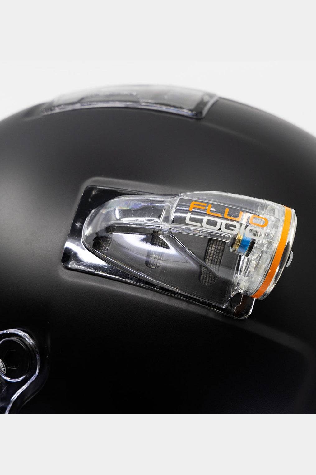 Bell BR8 helmet with FluidLogic air fitting installed on matte black surface