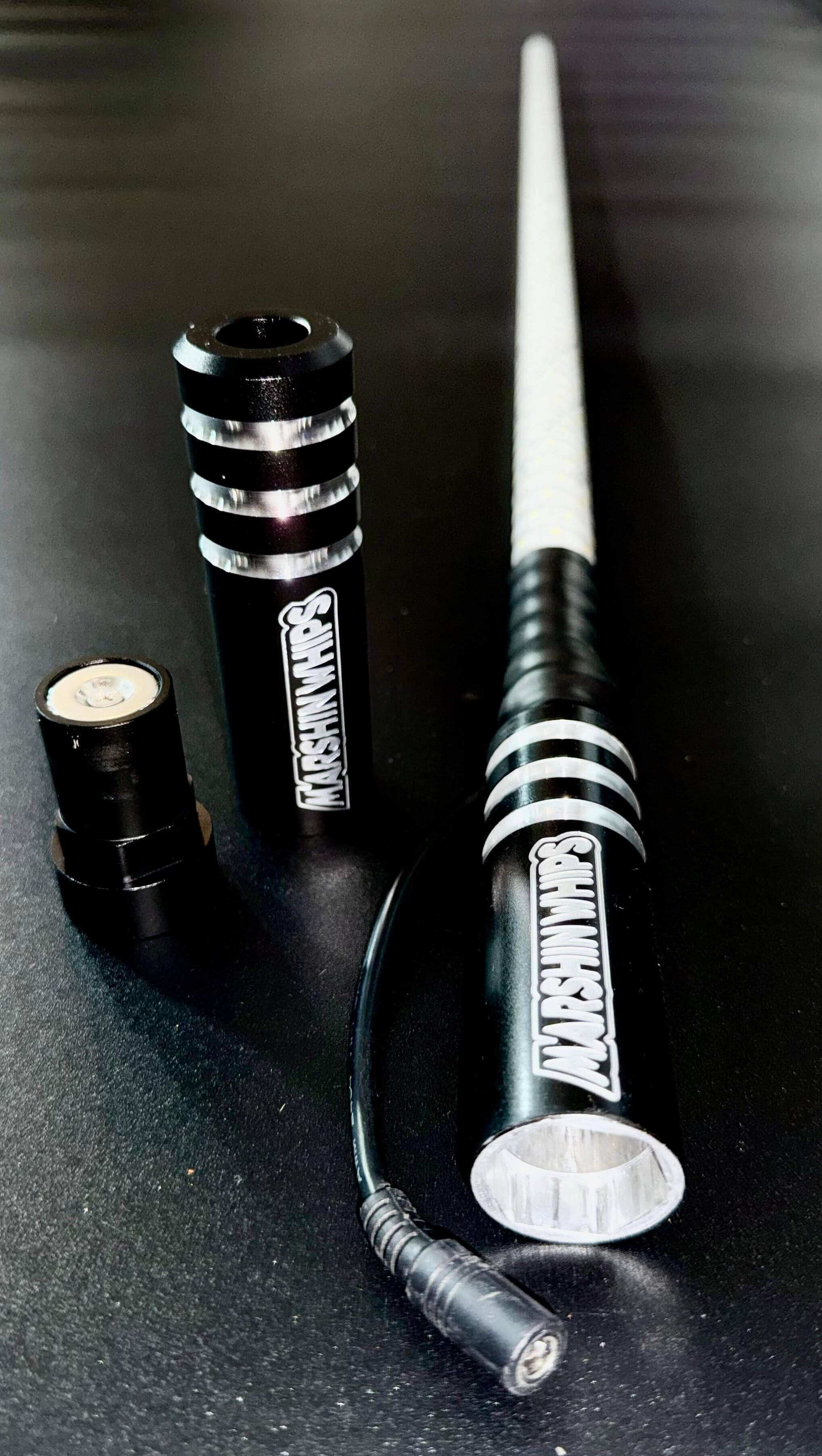 Game Changer Whip Black Single with magnetic base and LED lighting accessories on black surface