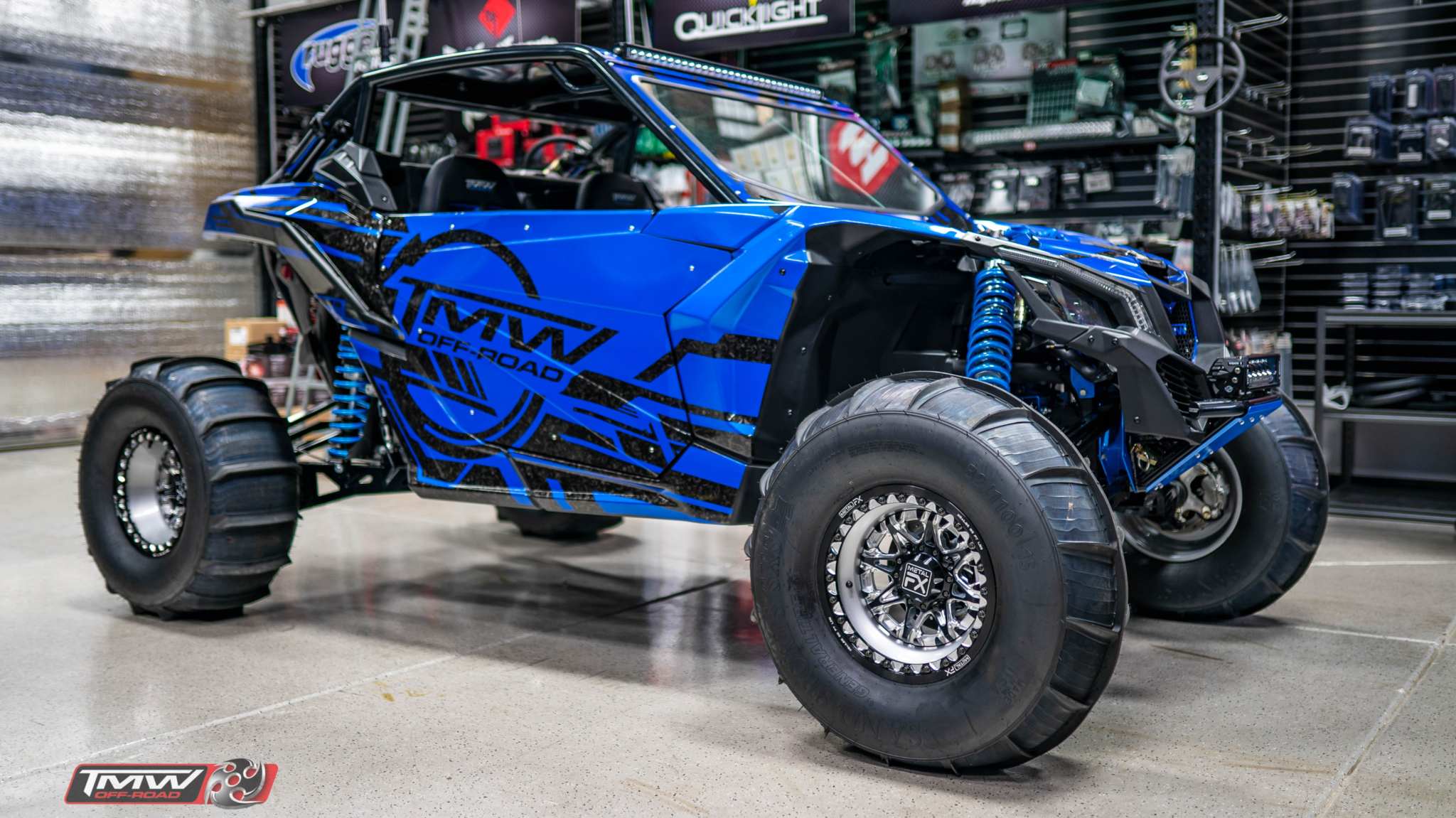 Blue TMW Can Am X3 off-road vehicle with full two-seat stealth doors and black powder-coated finish.