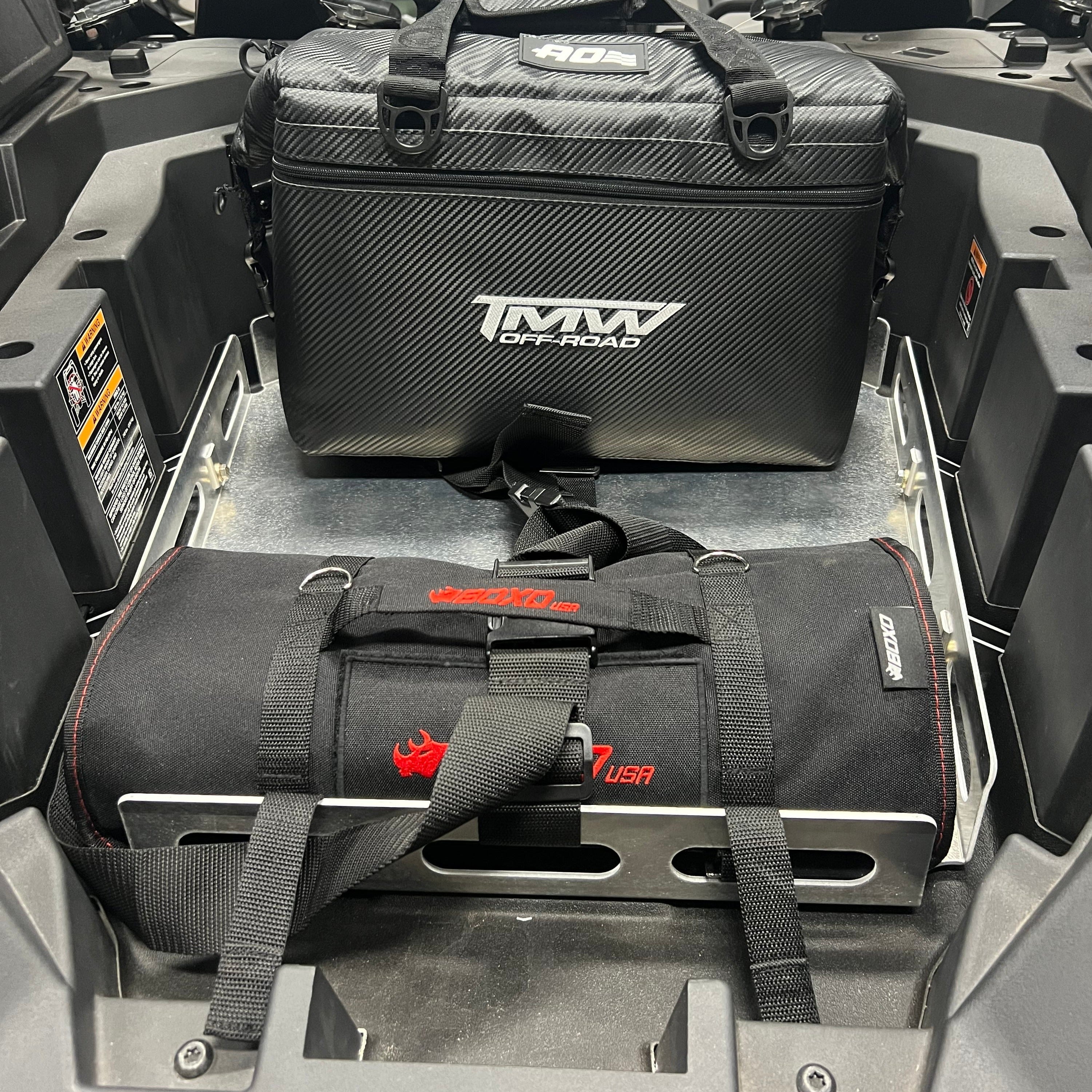 TMW PRO Cooler and Boxo tool roll secured on powdercoated black aluminum cargo rack in vehicle trunk