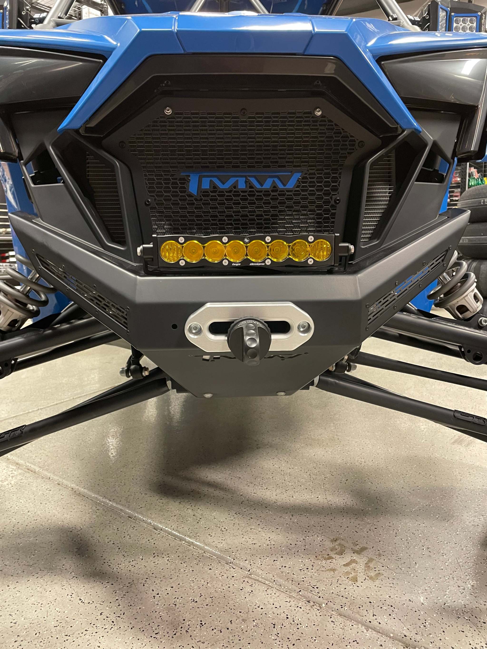 Front view of blue RZR PRO XP equipped with TMW DOMINATOR RZR PRO XP winch front bumper and LED light bar in black semi-gloss finish