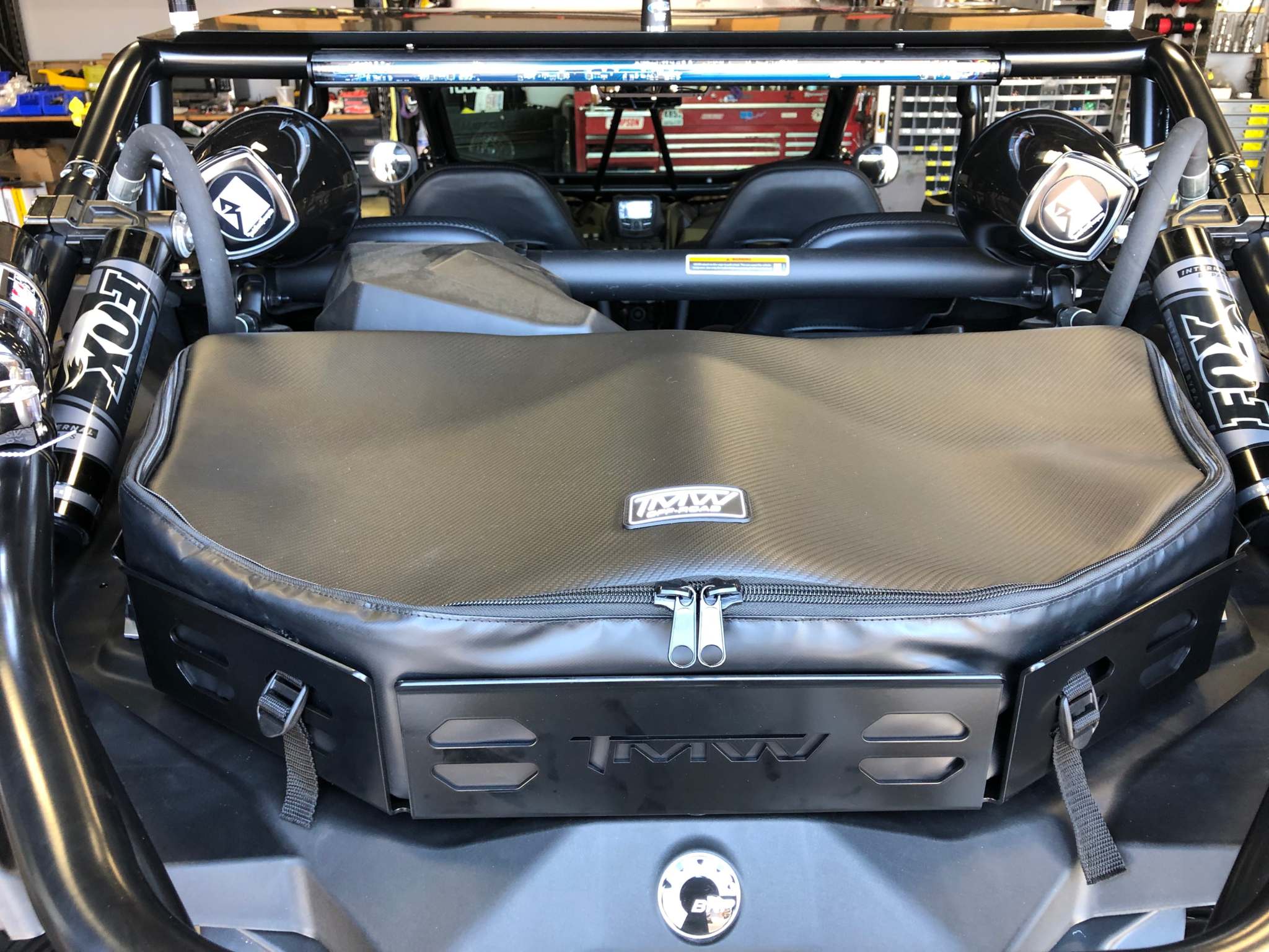 CanAm X3 Cargo bag attached to TMW Cargo Rack in offroad vehicle for secure storage of tools and supplies