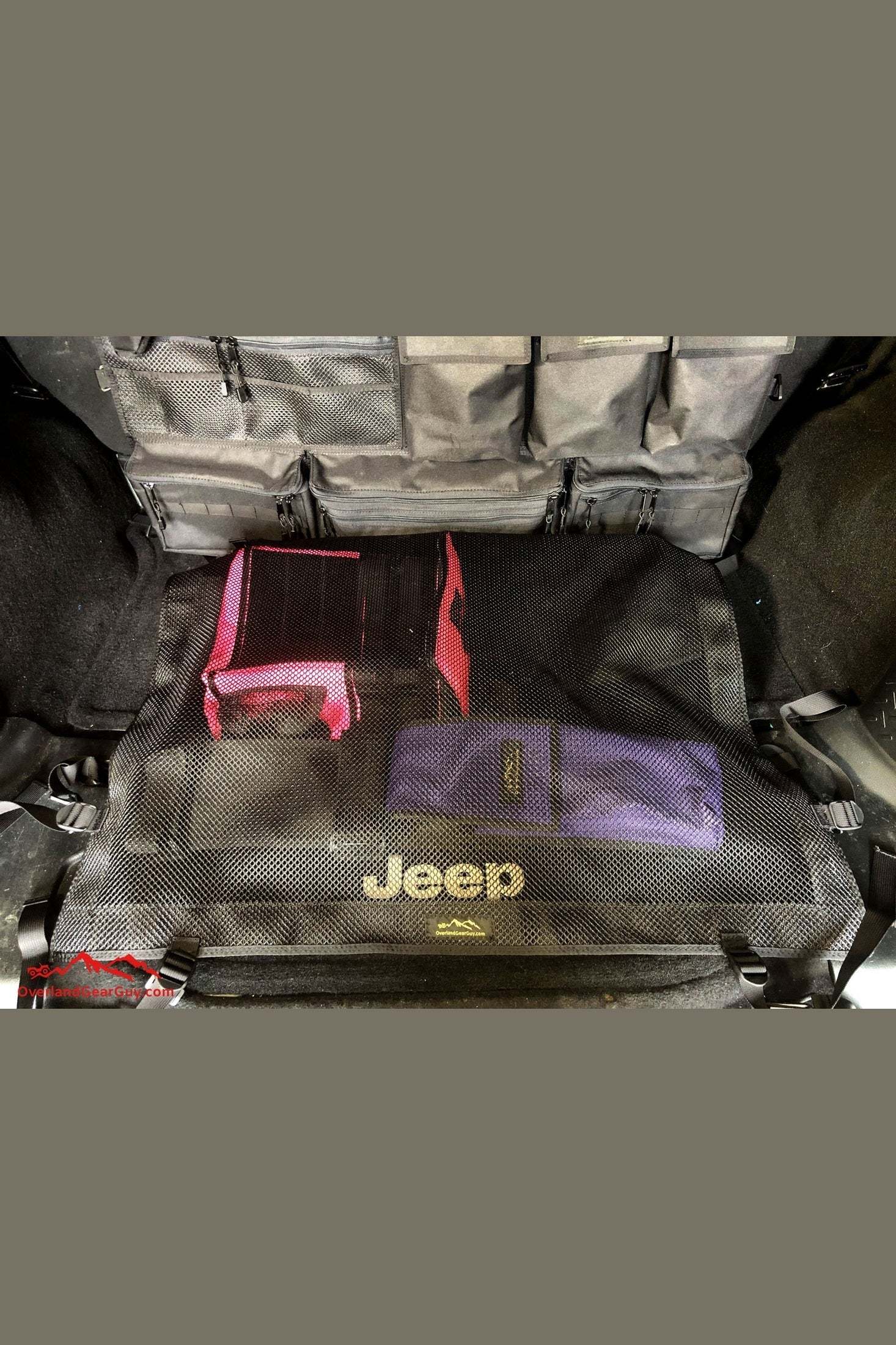 Jeep rear cargo net securing gear in trunk.