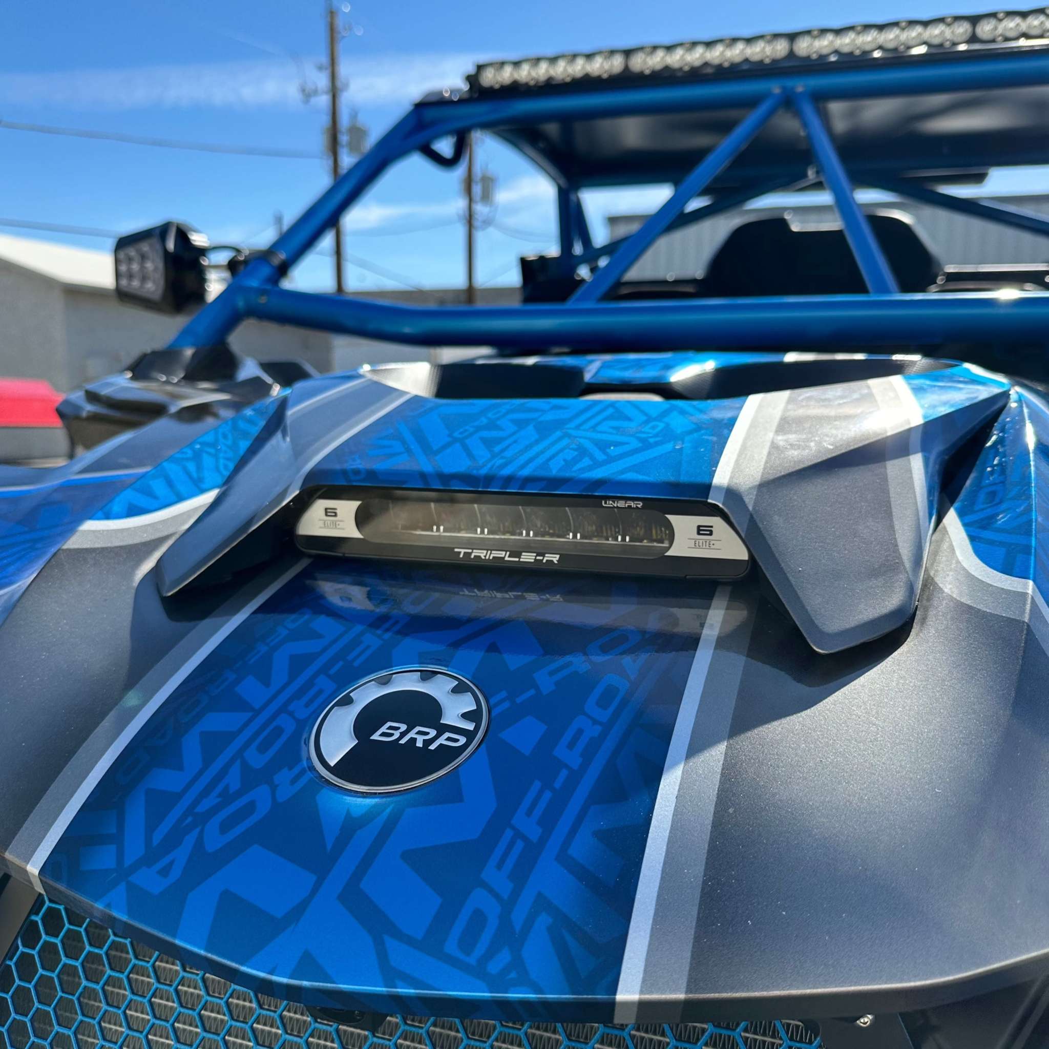 Triple R LINEAR-6 ELITE+ high-performance LED light mounted on blue off-road vehicle hood