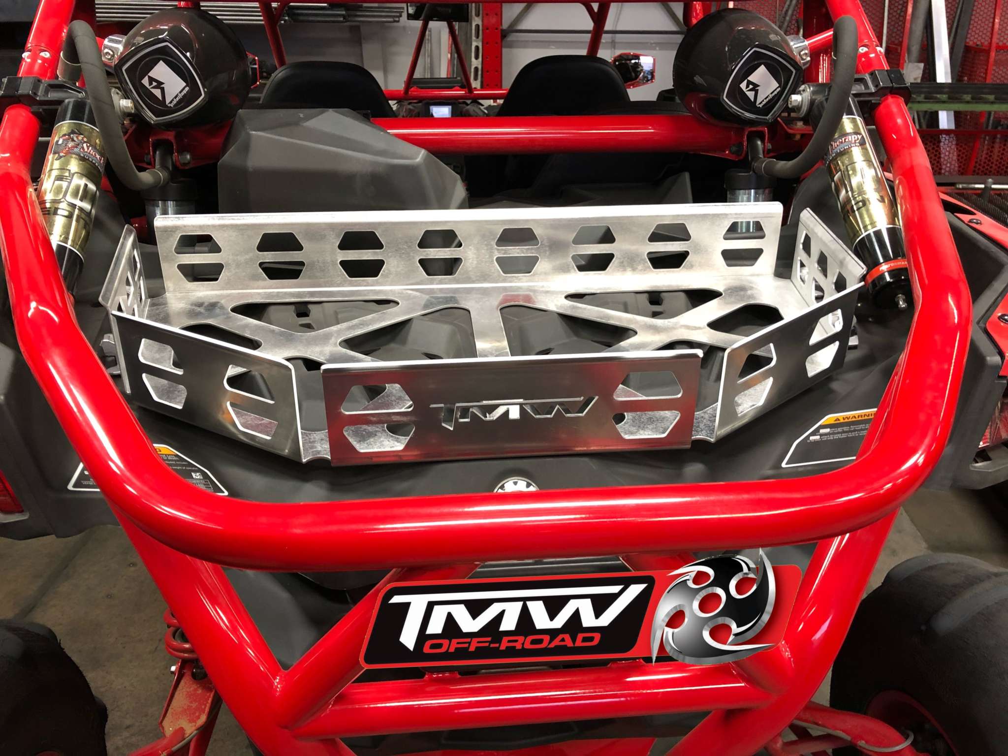 TMW X3 Maverick R aluminum cargo cooler and tool rack on red off-road vehicle frame