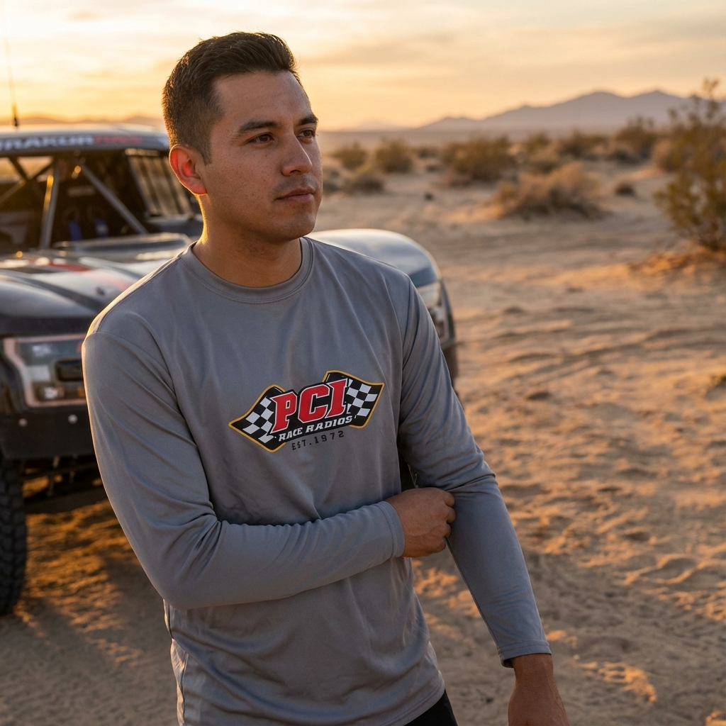 Man wearing charcoal gray PCI Solar UPF 50 long sleeve shirt with logo in desert setting