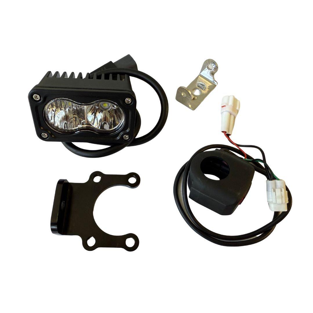 ATC Lighting Kit for Surron E-Bikes with LED light pod, wiring harness, and mounting brackets