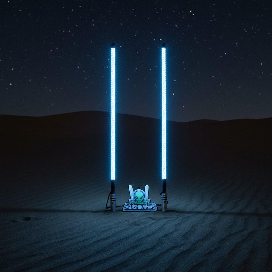 Marshin V3 Chrome Black LED whips with billet machined base glowing in desert night